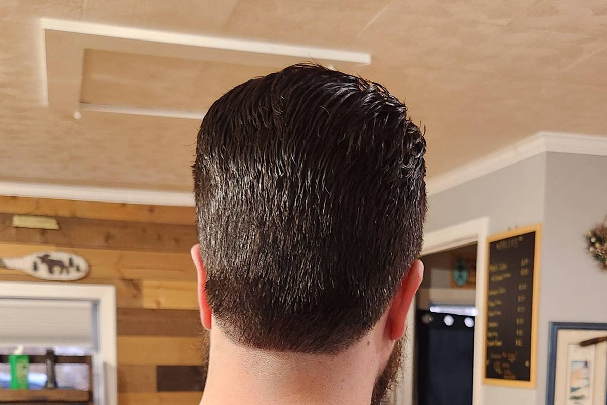 Back view of a men's cut by April, tapered at the neckline